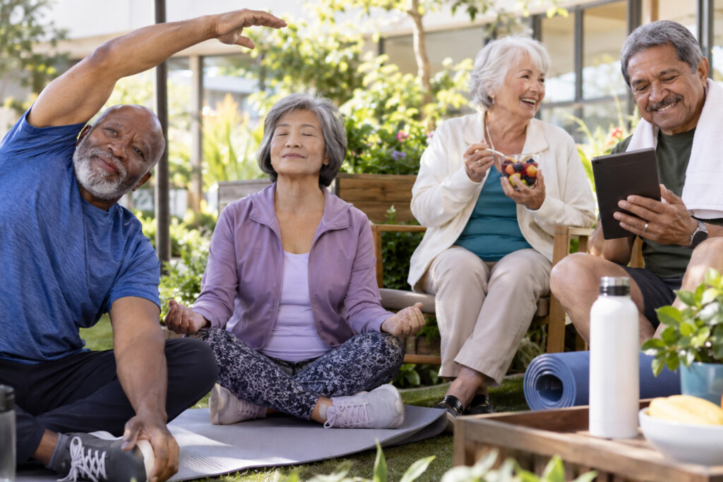 Diverse group of older adults practicing exercise, mindfulness, healthy eating, and using technology